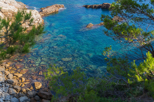 Picture of the intense turquoise color of Mediterranean sea in Sa Tuna beach at Begur town. Landscape of Costa Brava from above. Nature photography of blue sea, rocks and varied vegetation 