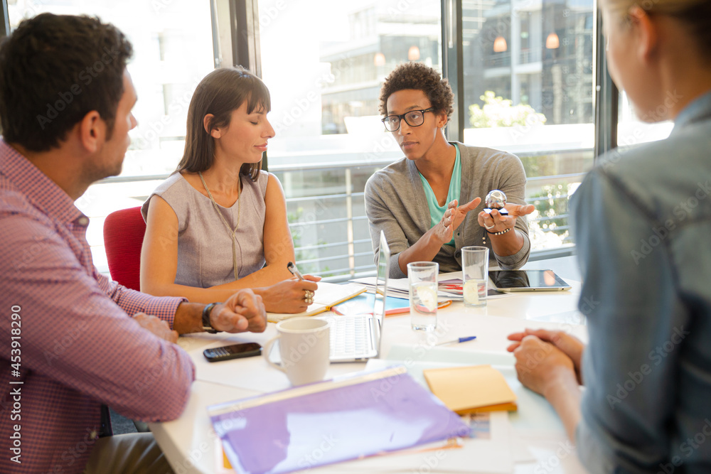 Business people examining model in meeting