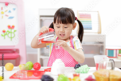 young girl pretend play food preparing at home
