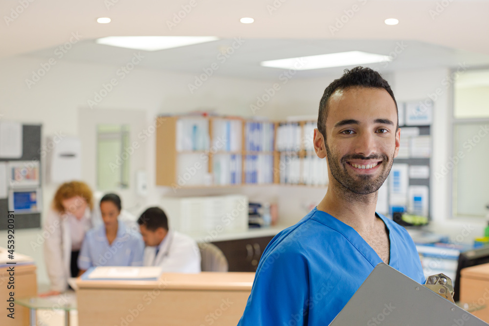 Doctor smiling in hospital hallway Doctor smiling in hospital hallway