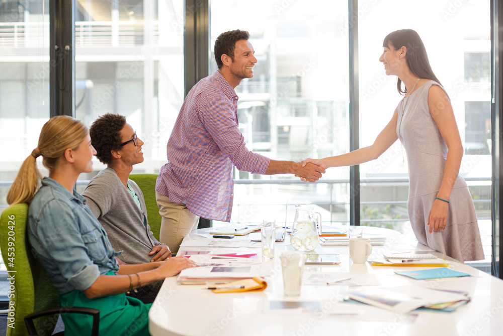 Business people shaking hands in meeting Business people shaking hands in meeting