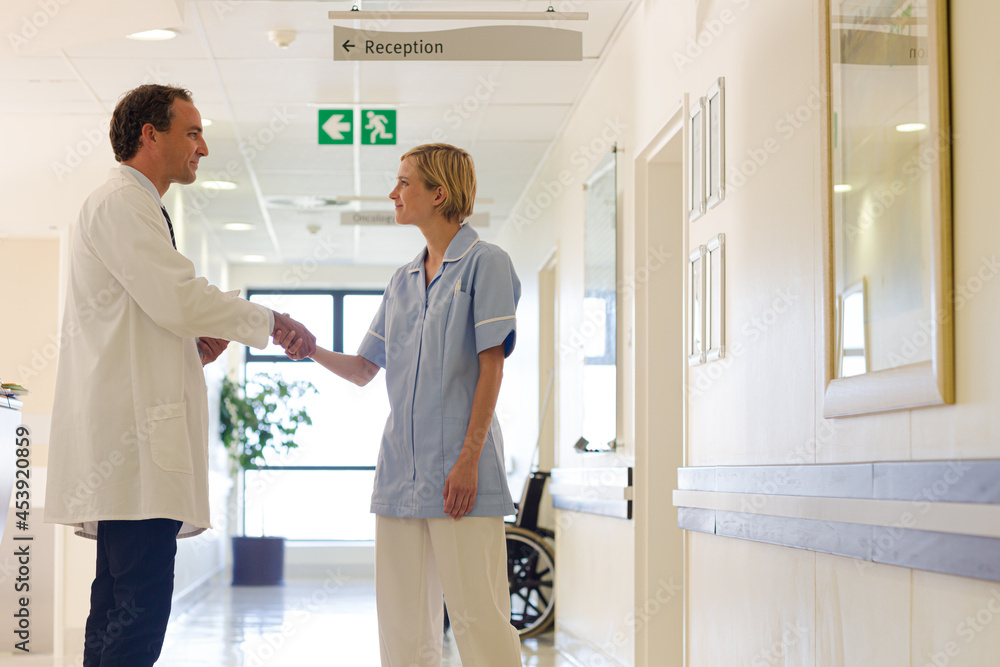 Nurse and doctor shaking hands in hospital Nurse and doctor shaking hands in hospital