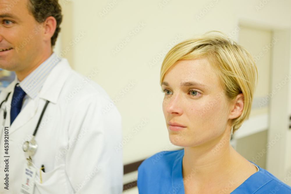 Fototapeta premium Nurse and doctor walking in hospital hallway
