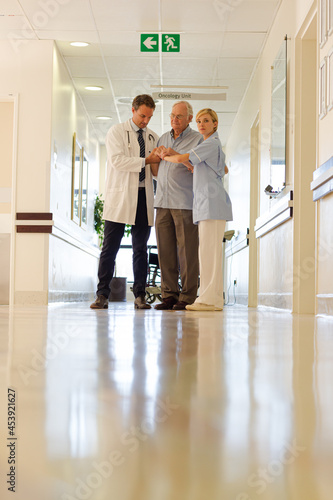 Doctor and nurse talking to patient in hospital room © KOTO