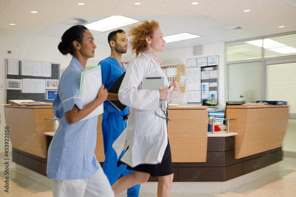 Hospital staff rushing down hallway Hospital staff rushing down hallway