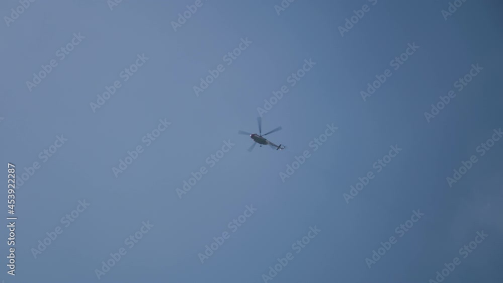 Helicopter flying against bright sun Helicopter flying against bright sun
