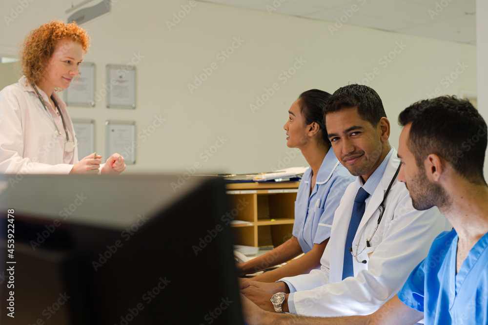 Hospital staff talking at front desk Hospital staff talking at front desk
