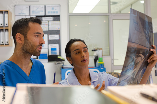 Surgeons examining x-rays in hospital