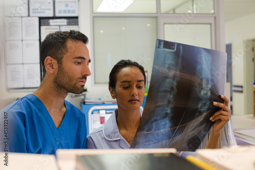 Surgeons examining x-rays in hospital