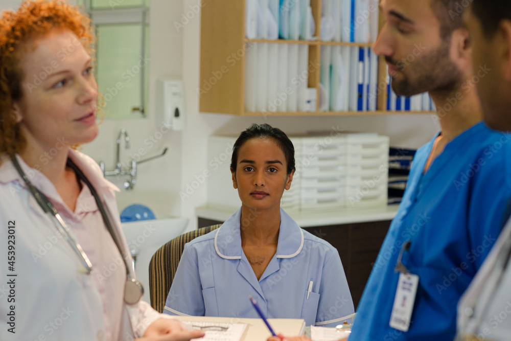 Hospital staff talking at front desk Hospital staff talking at front desk