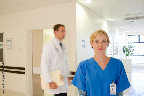 Doctor and nurse standing in hallway