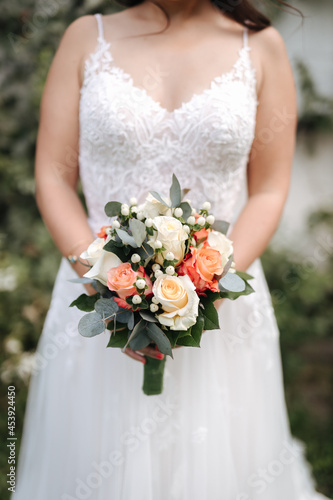 Bride holding beautiful wedding bouquet in her hands close-up