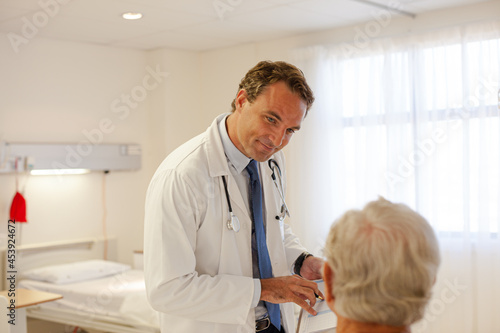 Doctor talking with patient in hospital room