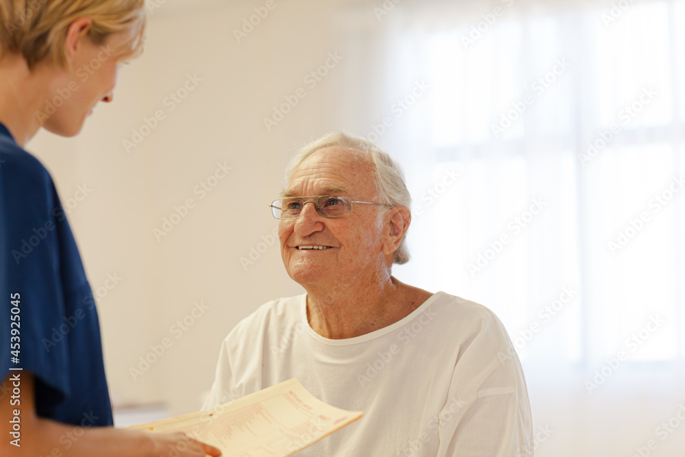 Nurse talking with older patient in hospital Nurse talking with older patient in hospital