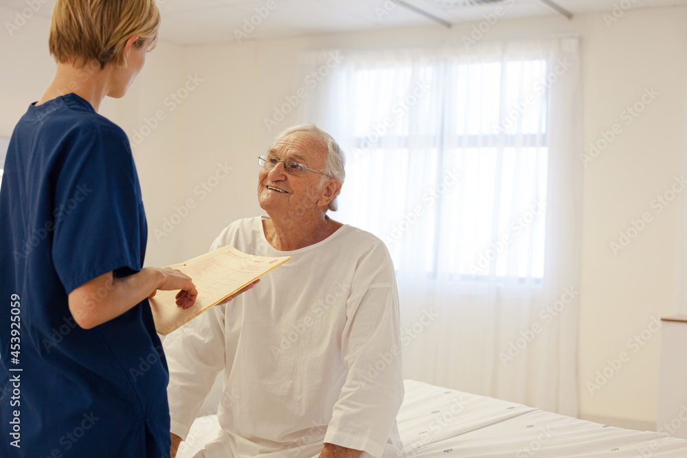 Obraz premium Nurse talking with older patient in hospital