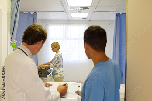 Doctors standing in hospital room