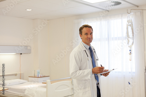 Doctor writing on clipboard in hospital