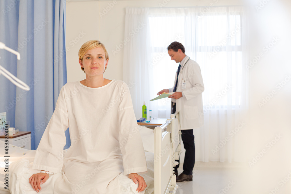 Patient wearing gown on hospital bed