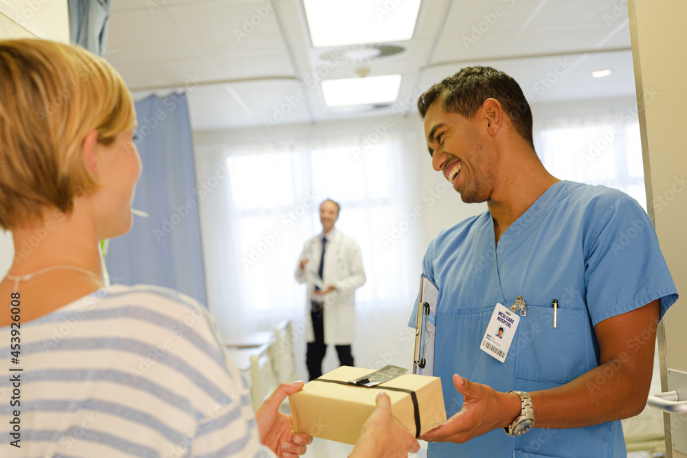 Patient giving nurse gift in hospital Patient giving nurse gift in hospital