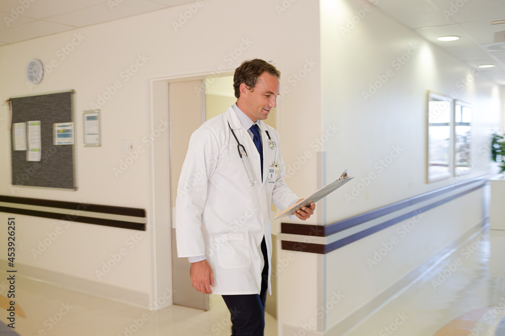 Doctor rushing in hospital hallway