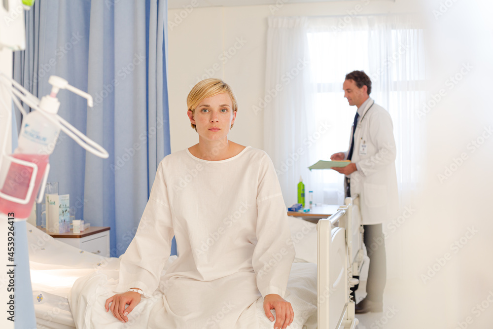 Fototapeta premium Patient wearing gown on hospital bed