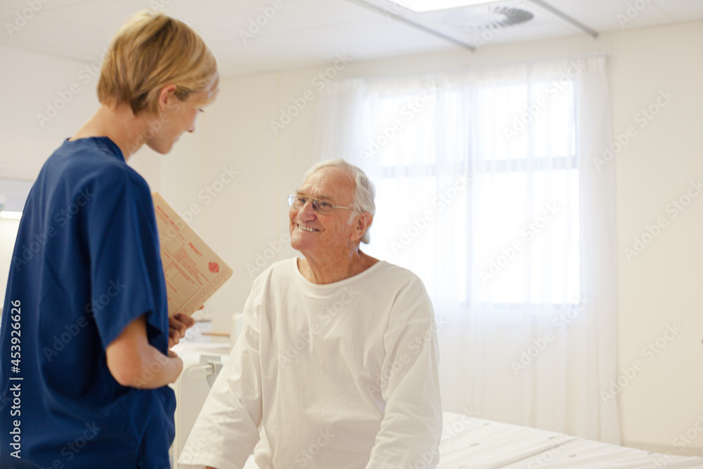 Nurse talking with older patient in hospital Nurse talking with older patient in hospital