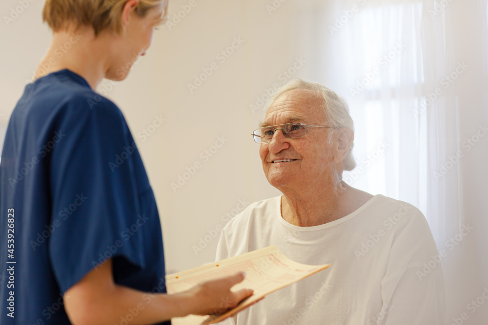 Nurse talking with older patient in hospital Nurse talking with older patient in hospital