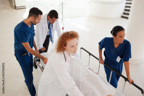 Hospital staff rushing patient to hospital room