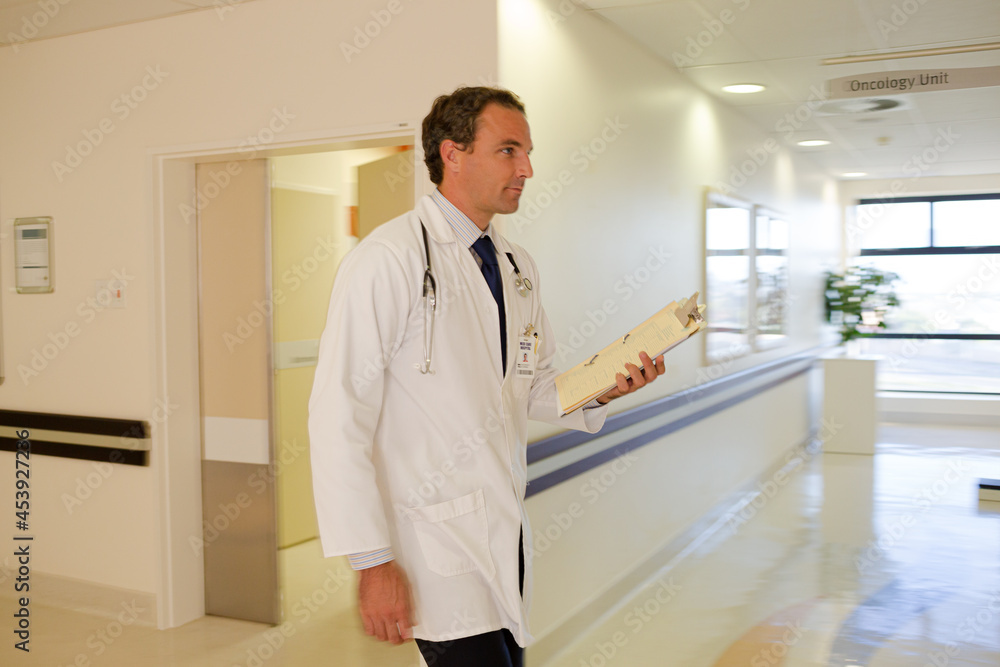 Doctor rushing in hospital hallway