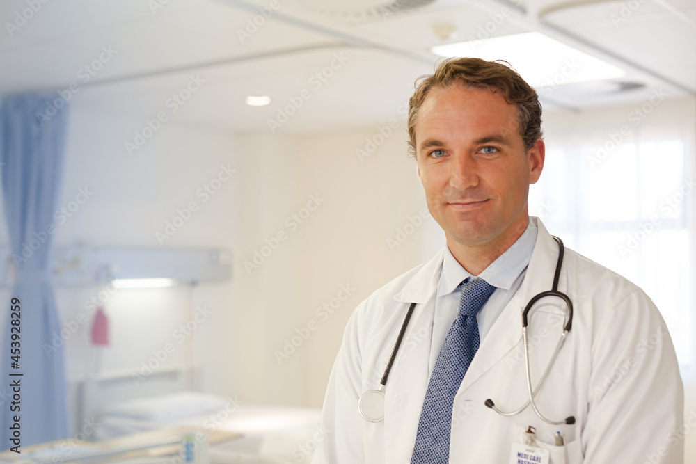 Doctor smiling in hospital hallway Doctor smiling in hospital hallway