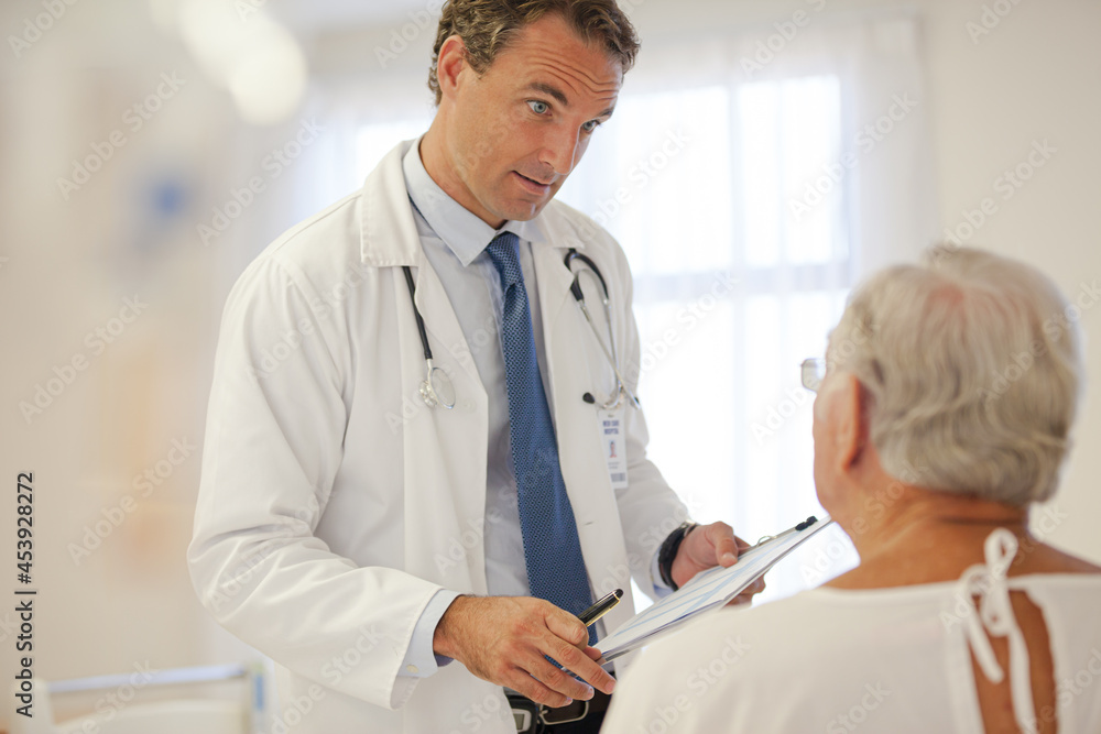 Fototapeta premium Doctor talking to older patient in hospital
