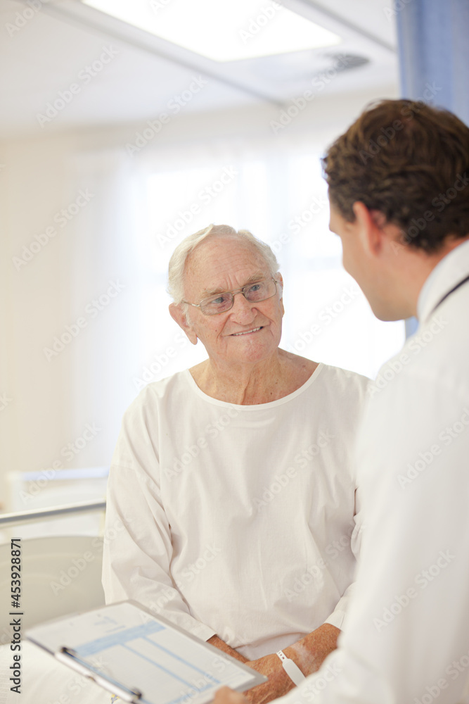 Fototapeta premium Doctor talking to older patient in hospital