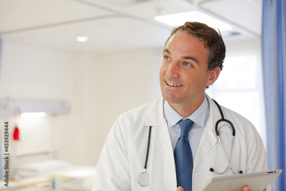 Doctor smiling in hospital room Doctor smiling in hospital room