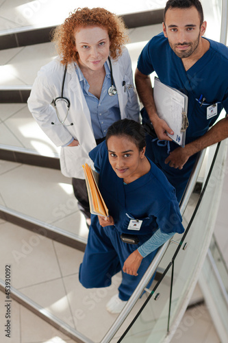 Doctor and nurses on hospital steps