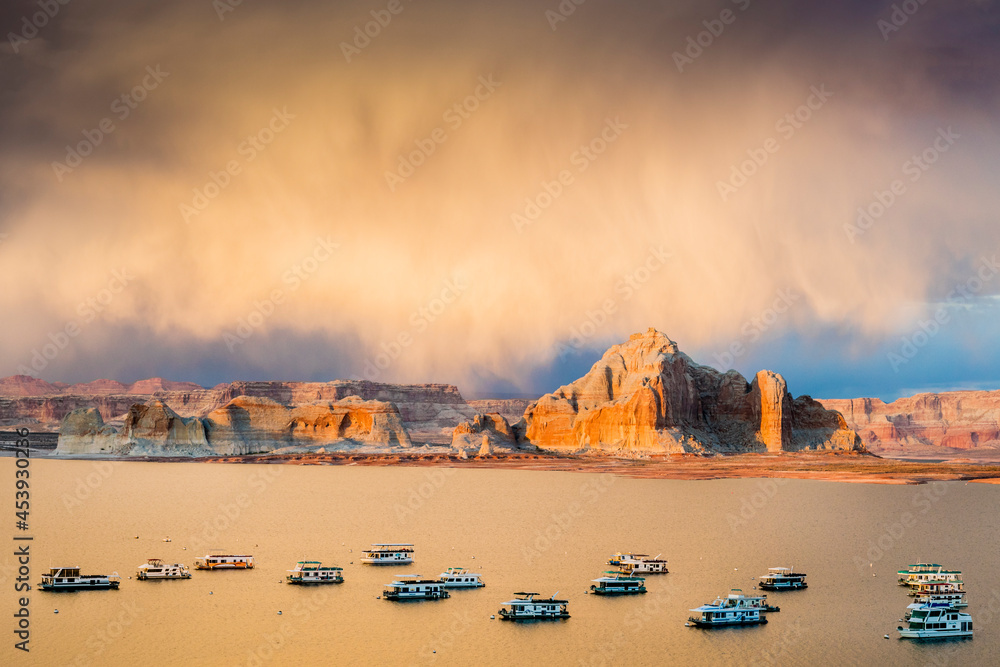 Houseboats on Glen Canyon and Powell Lake at sunset hours near the City of Page, Arizona, USA.