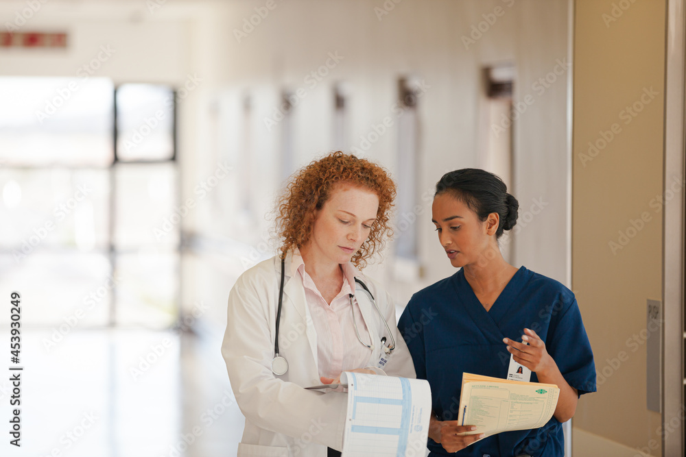 Fototapeta premium Nurse and doctor talking in hospital