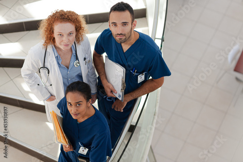 Doctor and nurses on hospital steps