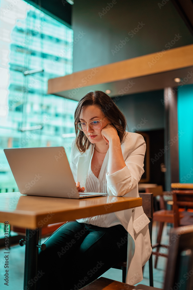 woman working on laptop in cafe woman working on laptop in cafe