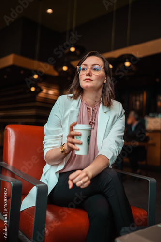 woman drinking coffee in a coffee shop