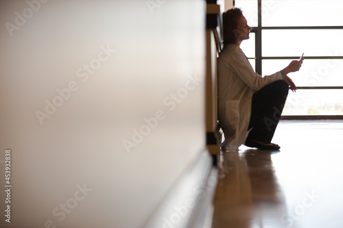 Wallpaper Mural Doctor using cell phone in hospital hallway Torontodigital.ca