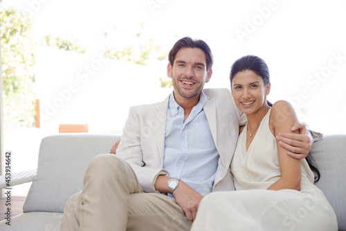 Portrait of smiling couple on sofa © KOTO