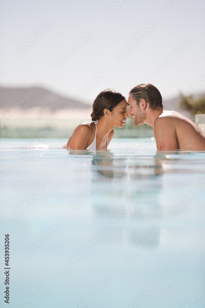 Fototapeta premium Couple relaxing together in swimming pool