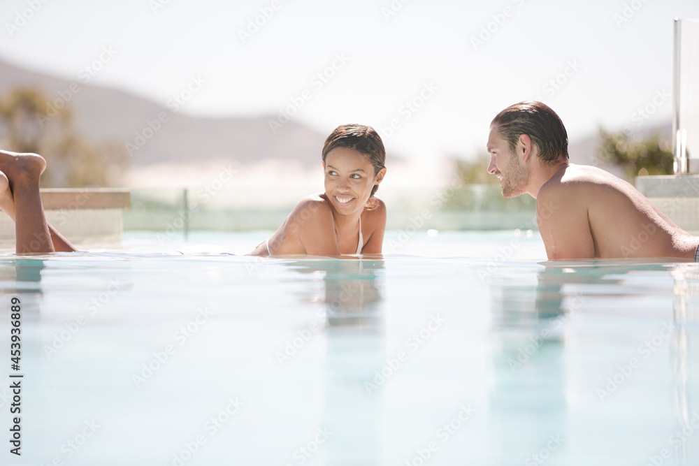 Couple relaxing together in swimming pool Couple relaxing together in swimming pool