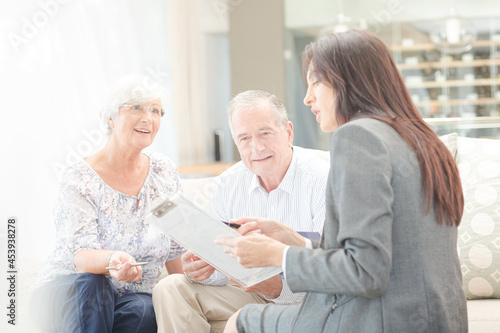 Financial advisor talking to couple on sofa