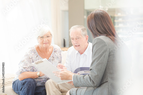 Financial advisor talking to couple on sofa © KOTO