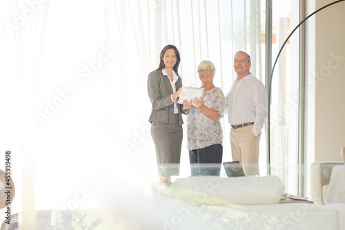 Financial advisor talking to couple indoors © KOTO