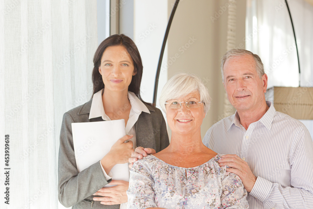 Financial advisor posing with clients Financial advisor posing with clients