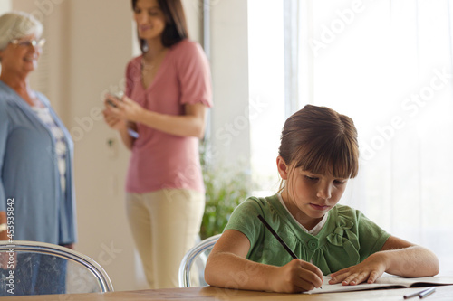 Girl doing homework at table