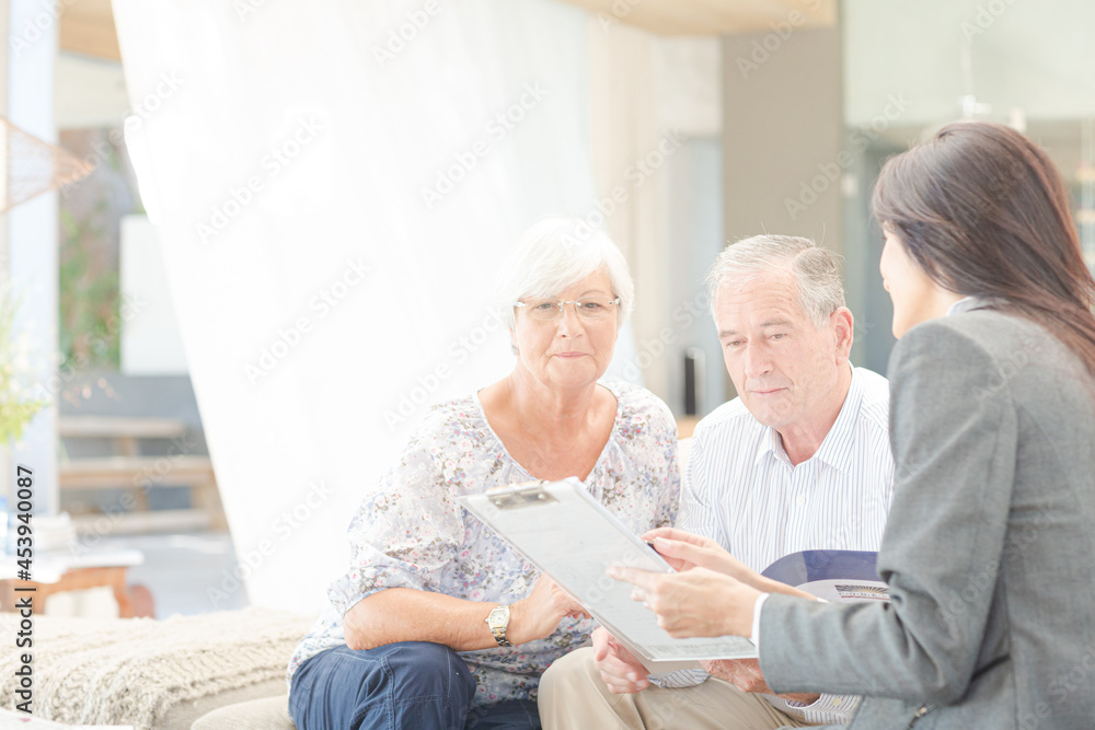 Financial advisor talking to couple on sofa Financial advisor talking to couple on sofa