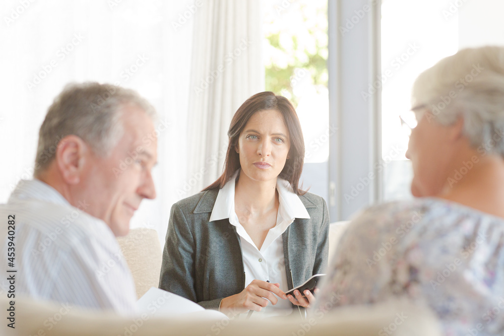 Financial advisor with couple on sofa Financial advisor with couple on sofa